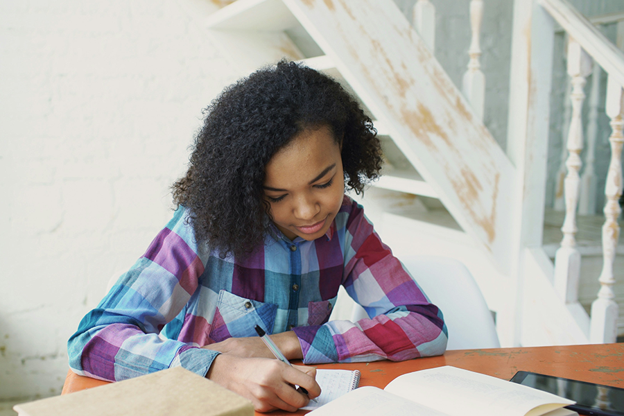 Teen girl studying at home