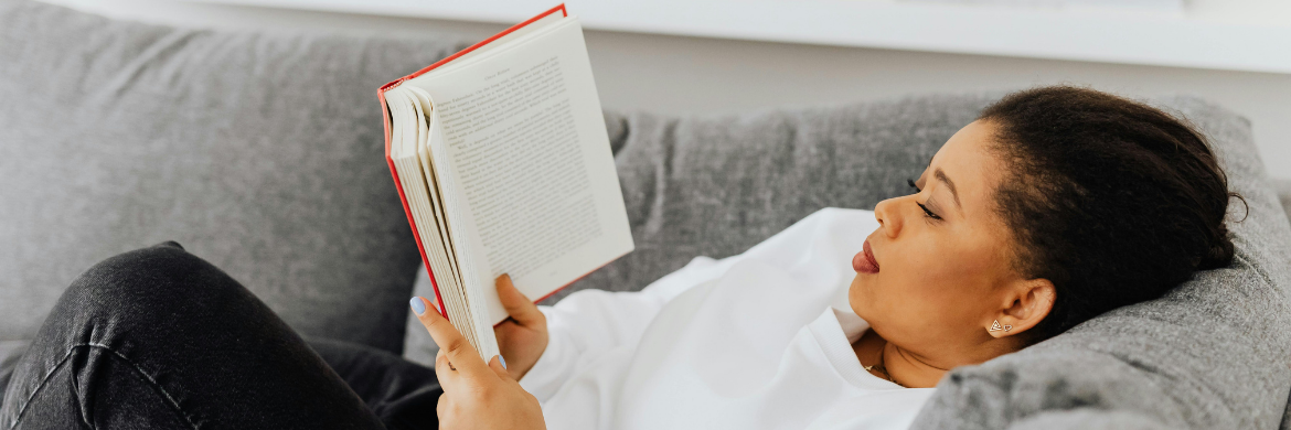 Woman on a couch reading a book