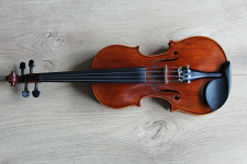 Violin lying on a light grey flooring