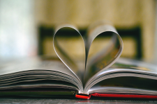 Open book with the inner pages curled inward to create a heart