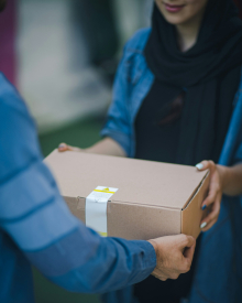 close up of two people exchanging a box