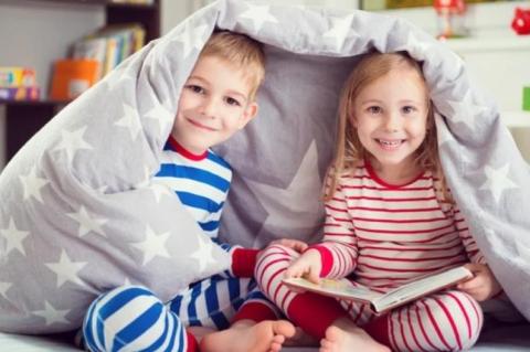 children reading under blanket