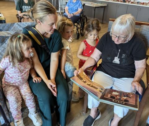 Senior adult reading to children