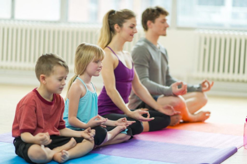 family practicing yoga