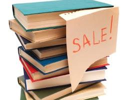 Stack of books with a Sale sign