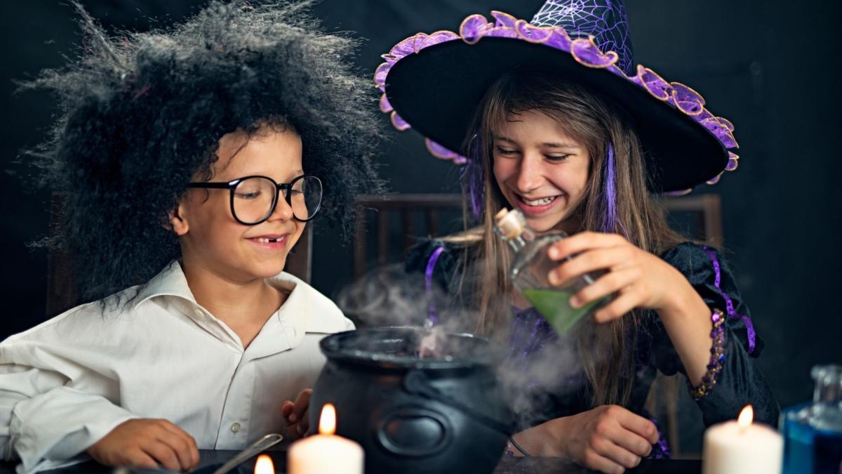 boy and girl pouring liquid into a caldron 
