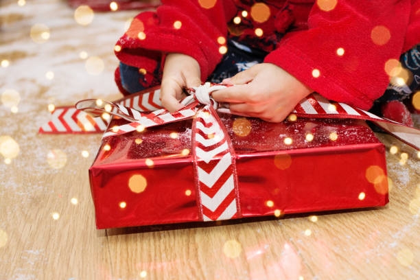 Child's hands unwrapping a present