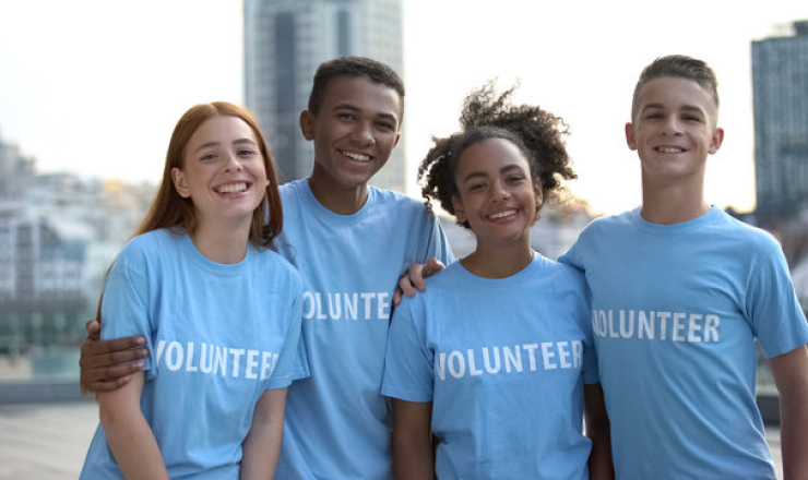 Group of teens wearing volunteer shirts